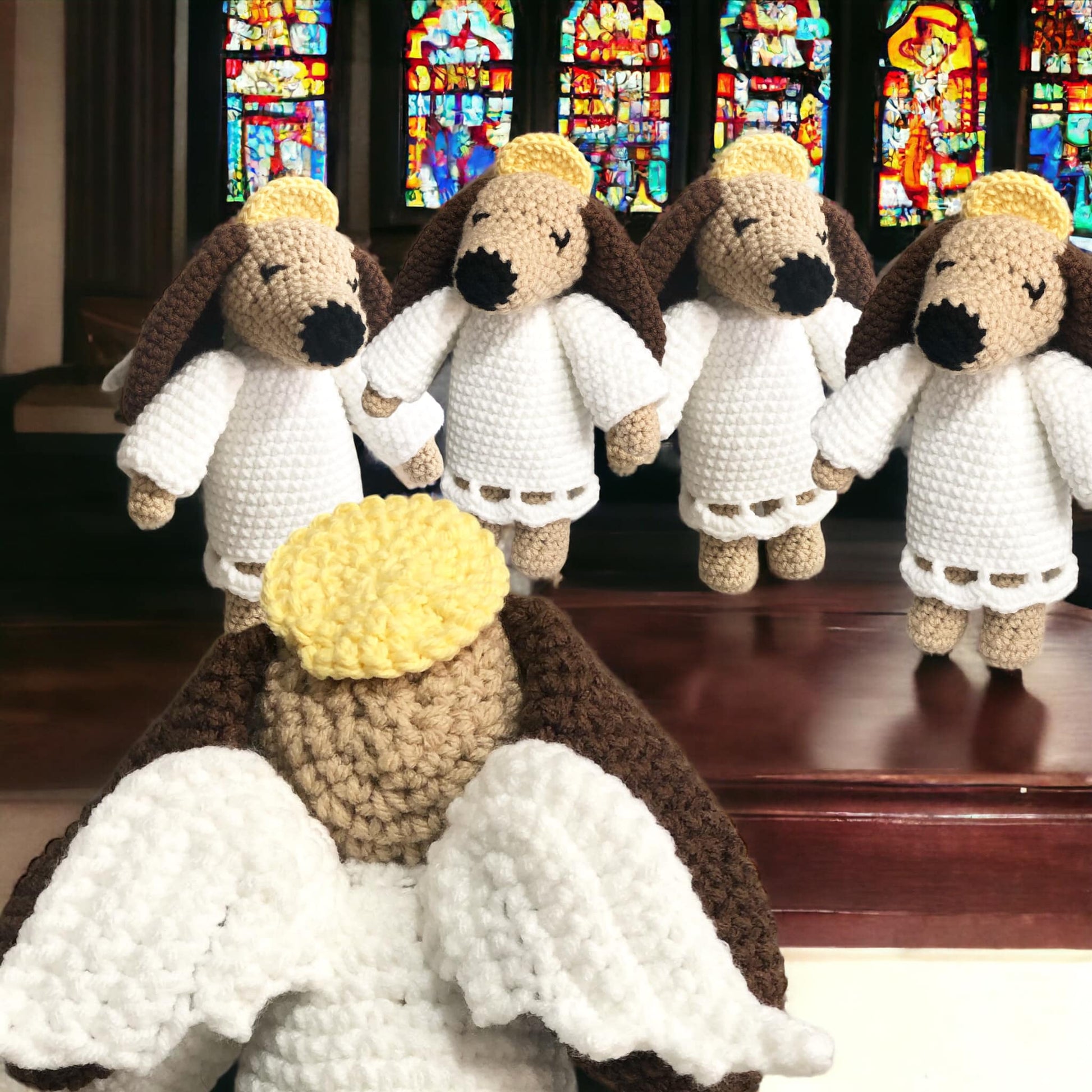 A group of crochet angel dog dolls standing together in a church.