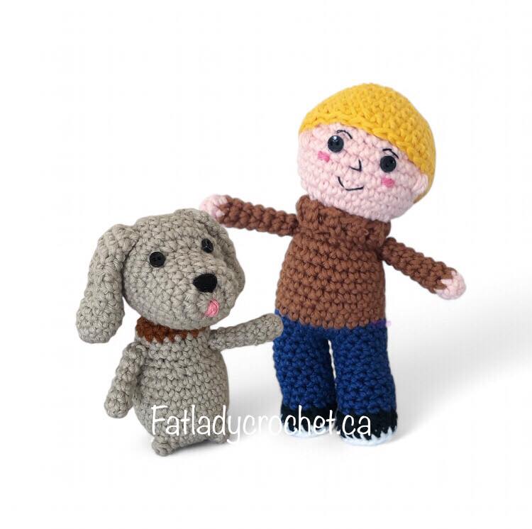 Casey, a child, and Finnegan, a grey dog, standing together against a white backround