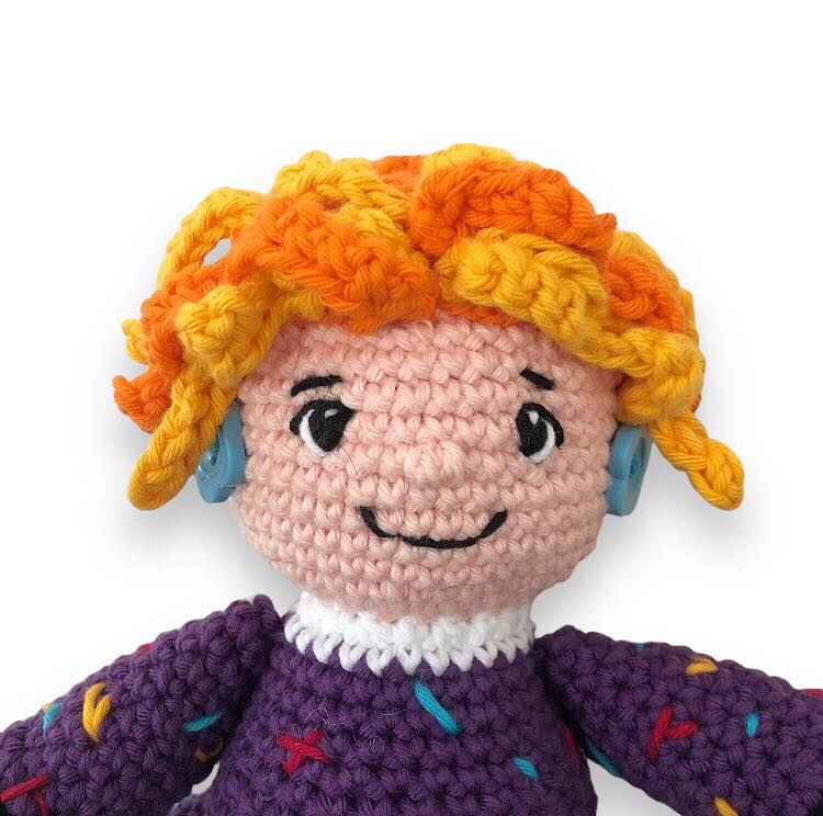 Crocheted Mrs. Frizzle close-up on a white backround