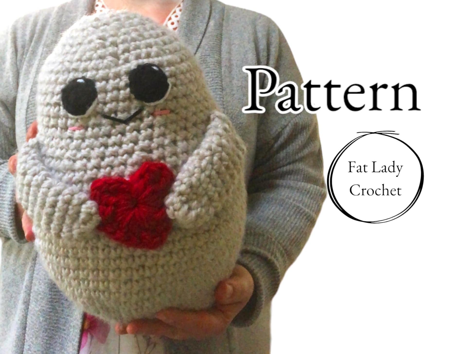 A crocheted potato with a red heart and large eyes being held up by a person with text that says "Pattern," and "Fat Lady Crochet."