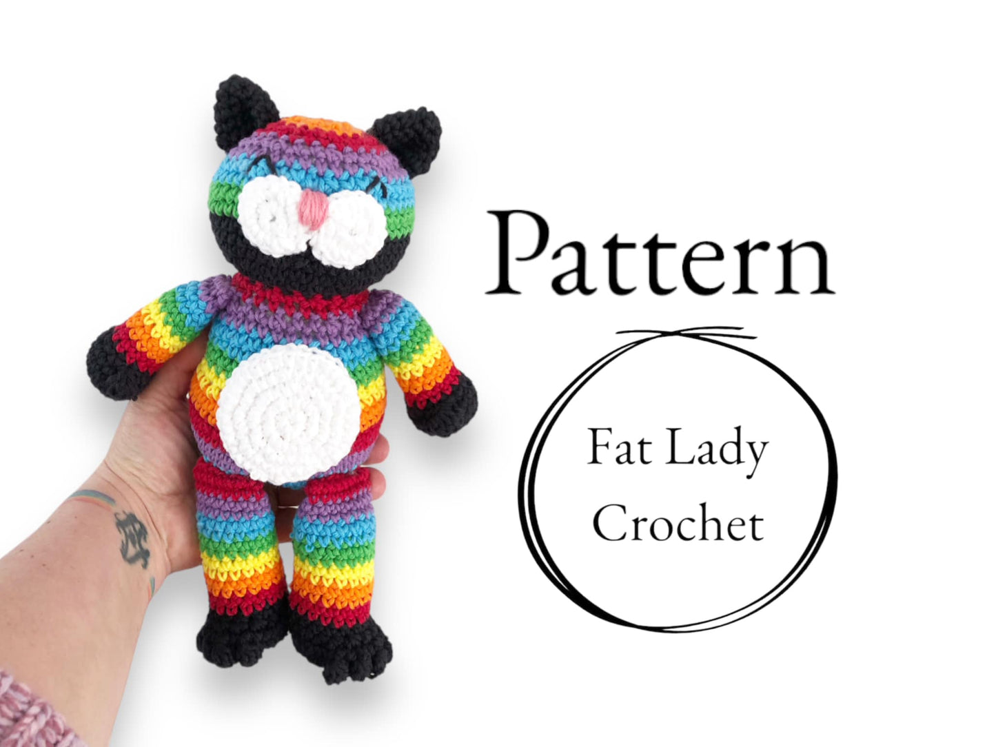 A crocheted rainbow cat doll being held up against a white background with text that says "Pattern" and "Fat Lady Crochet."