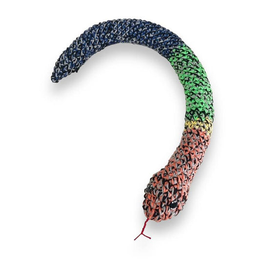 A crocheted rainbow rattle snake laid out against a white background.