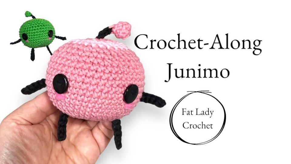 A pair of crochet junimos from the game Stardew Valley, one pink and one green, with text that says "Crochet-Along Junimo," and "Fat Lady Crochet."