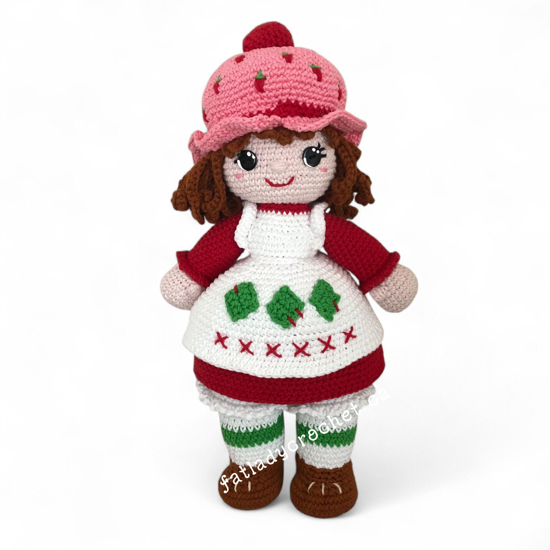 Crocheted Strawberry shortcake doll set against a white background