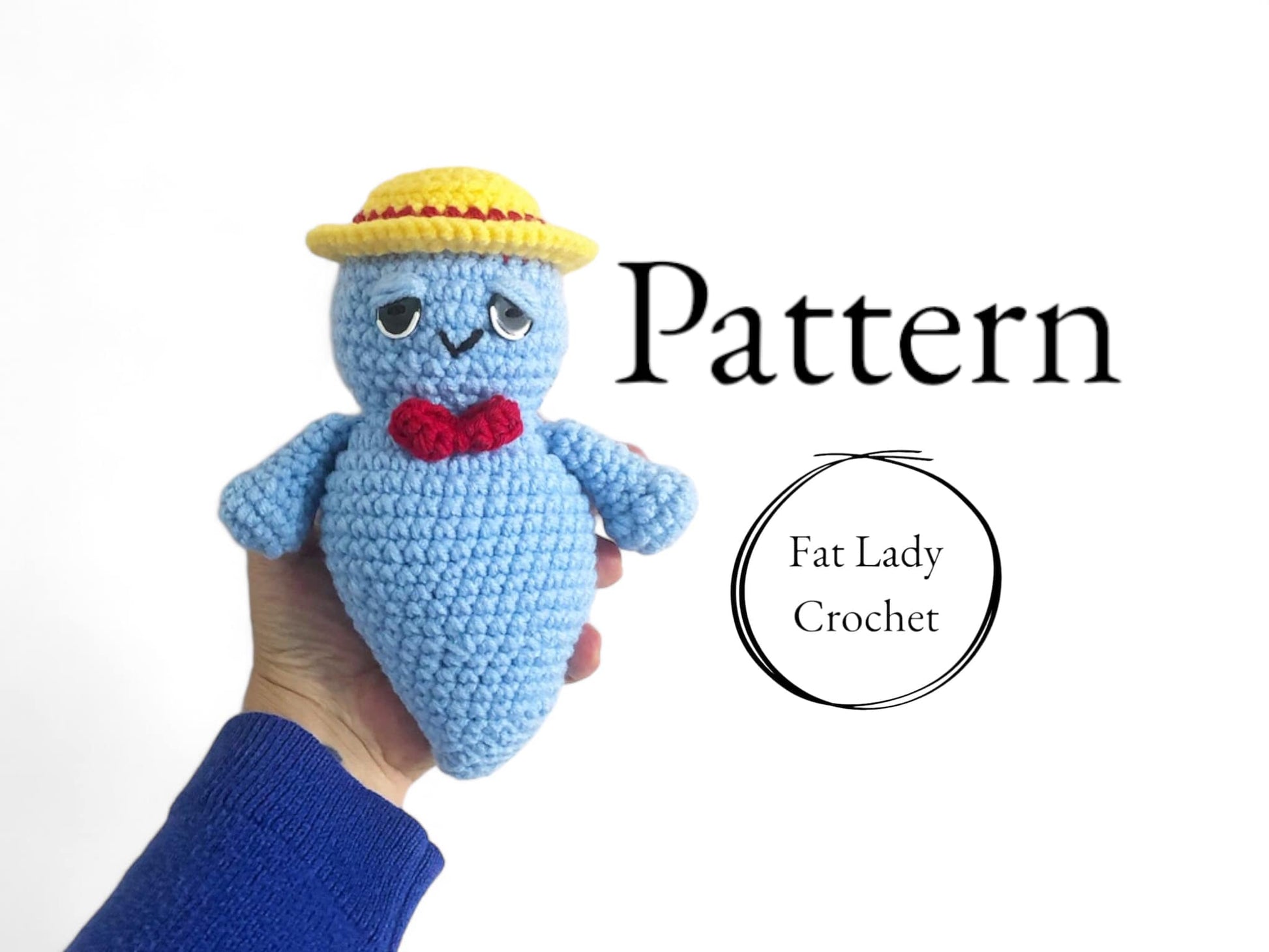 A crochet doll of Boo Berry being held against a white background with text that says "Pattern" and "Fat Lady Crochet"