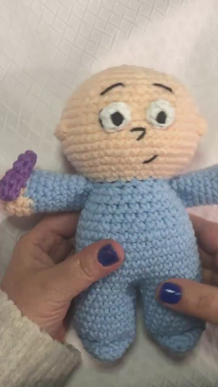 A video of a crocheted doll resembling Harold from Harold and the Purple Crayon.