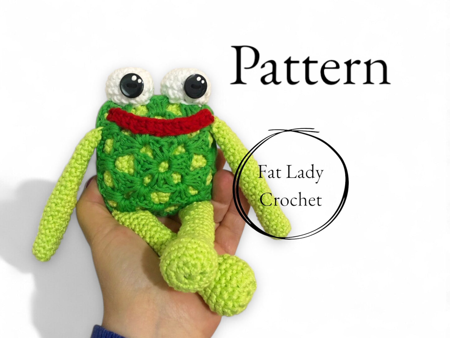 Hand holding a green crochet frog toy with 'Fat Lady Crochet' branding.
