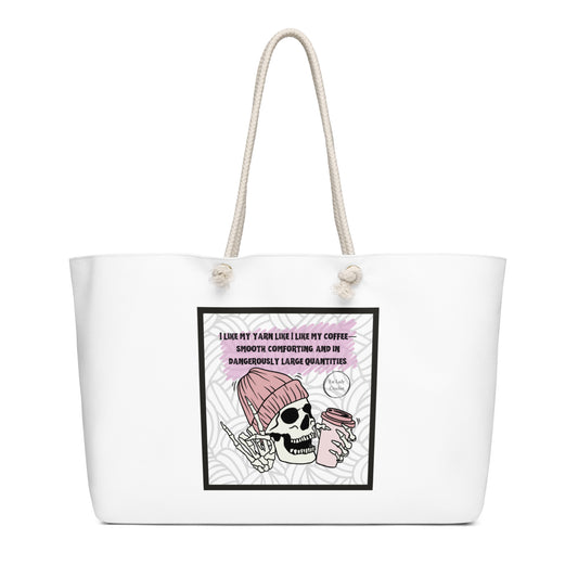 White tote with skull wearing a beanie and holding a cup of coffee and making the rock-on hand sign, underneath the quote "I like my yarn like I like my coffee. Smooth, comforting, and in dangerously large quantities" 