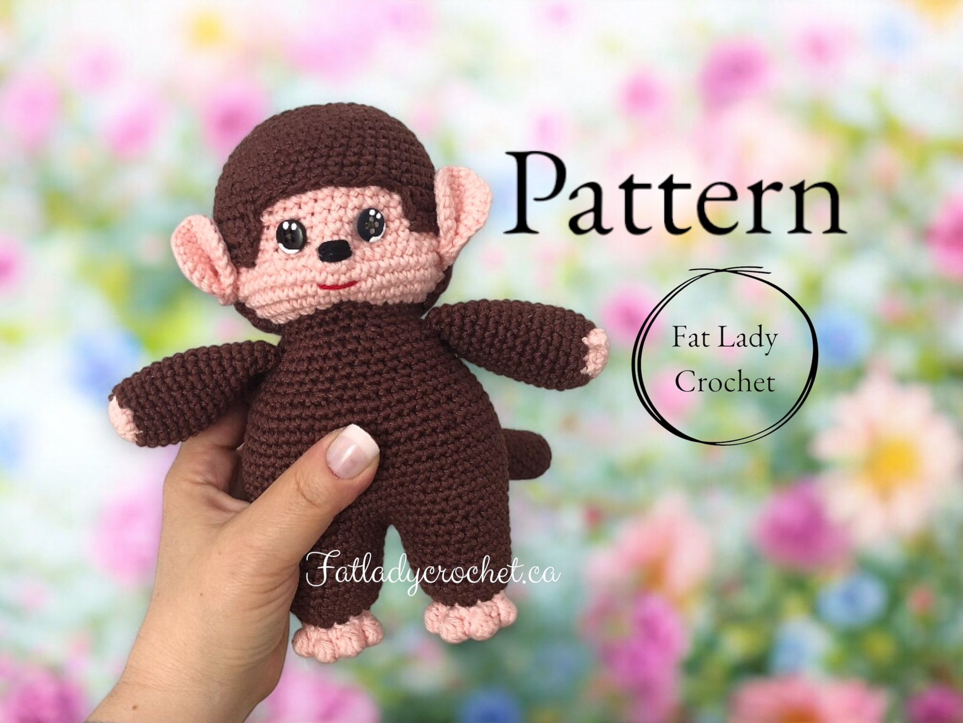 A hand holding a crochet monchhichi doll against a blurred flower background with Fat Lady Crochet branding. 