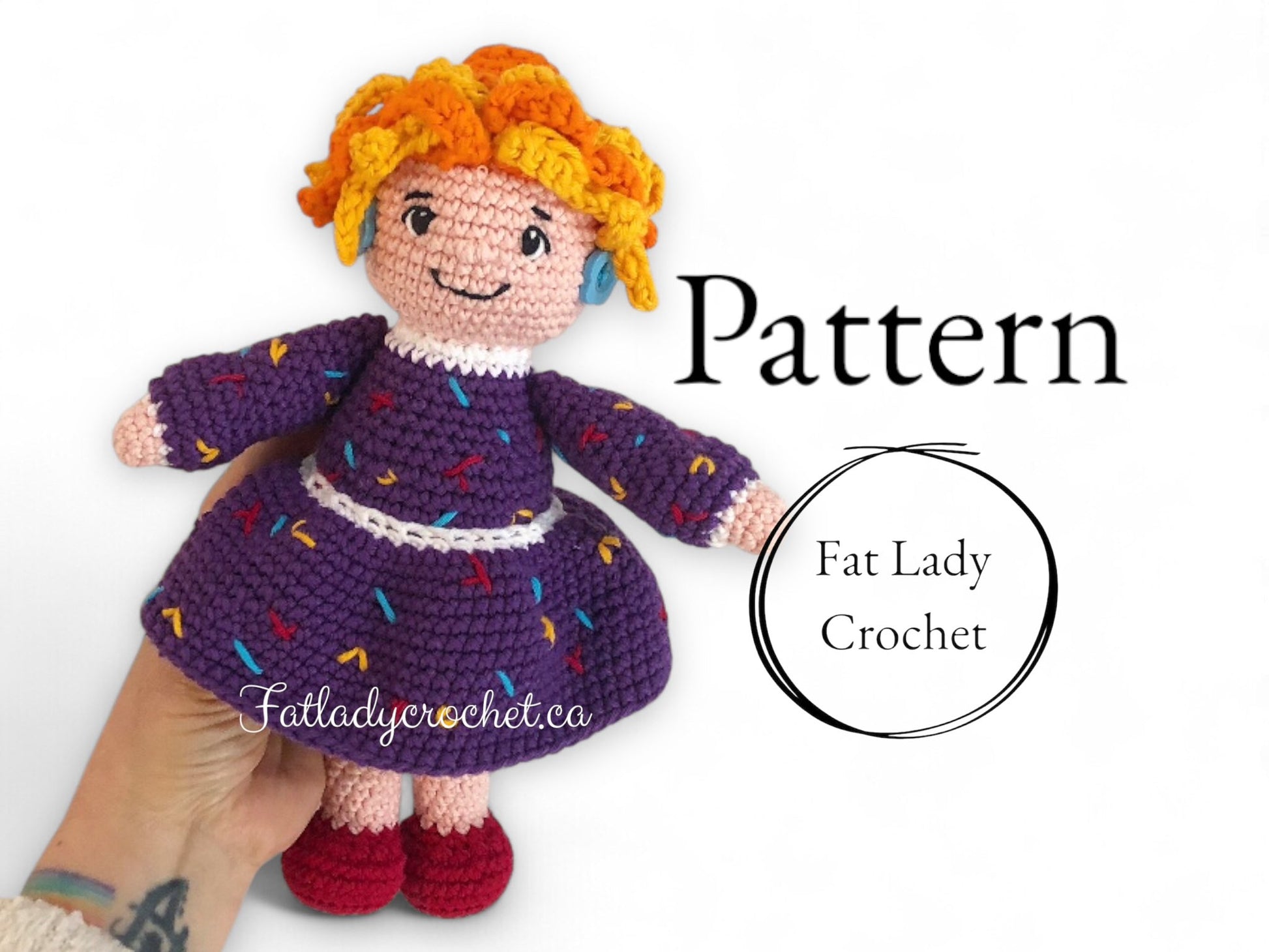 Crocheted Mrs. Frizzle doll being held up against a white background with "Fat Lady Crochet" branding. 