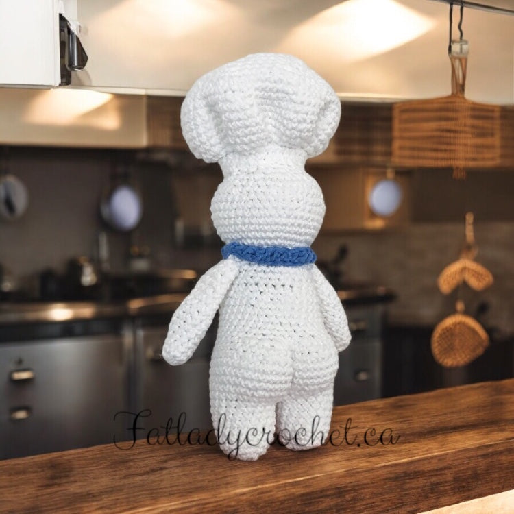 Pillsbury doughboy set inside an industrial kitchen facing away from camera with bubble butt visible. 