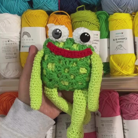 a 20 second video of Mr. Fabu the granny square frog being shown off to the camera against a background of various yarn balls
