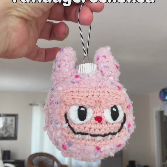 An 8 second video showing off the free Labubu ornament pattern with a logo at the top of the video that says Free Pattern: Fatladycrochet.ca 