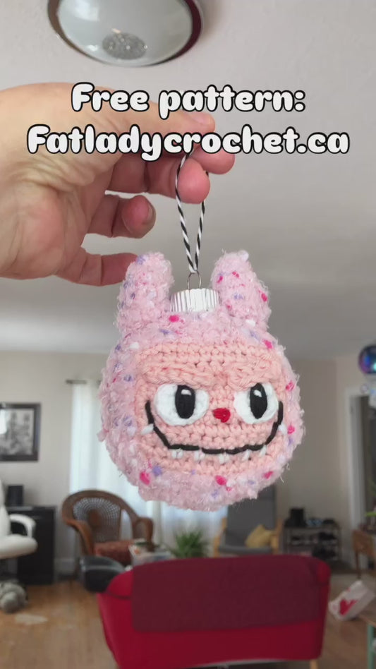 An 8 second video showing off the free Labubu ornament pattern with a logo at the top of the video that says Free Pattern: Fatladycrochet.ca 
